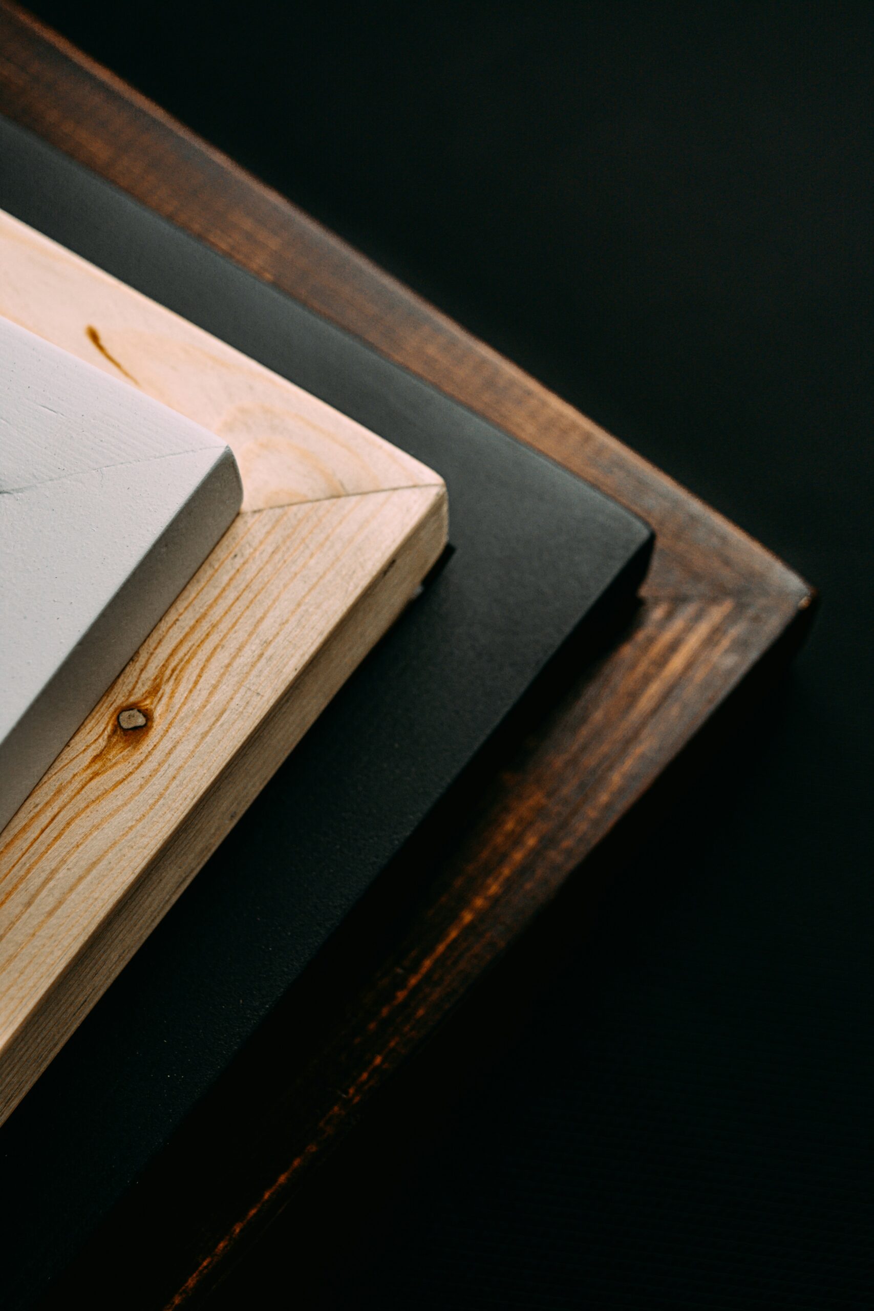 Wood frames in different color on black background 